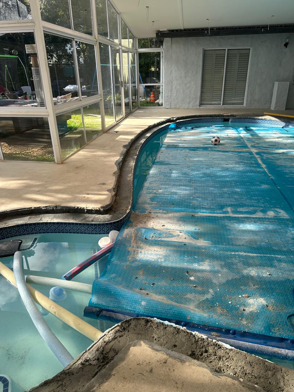 Before photos of a pool pebble paving job in Cape Town