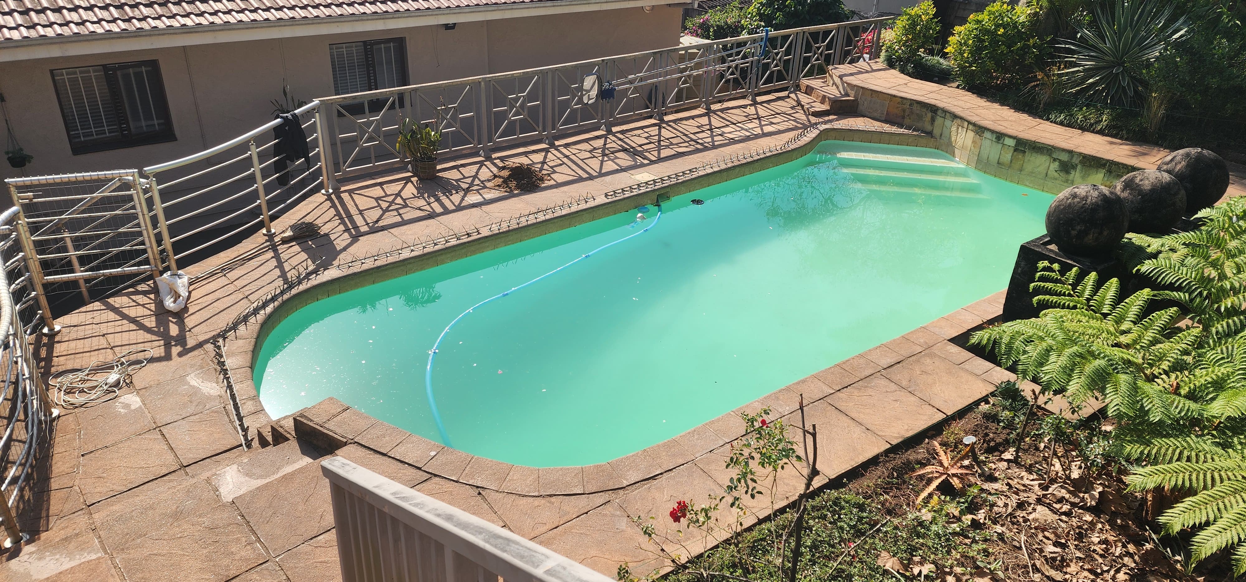 Flagstones around a pool just waiting for some pebble paving to elevate it's look